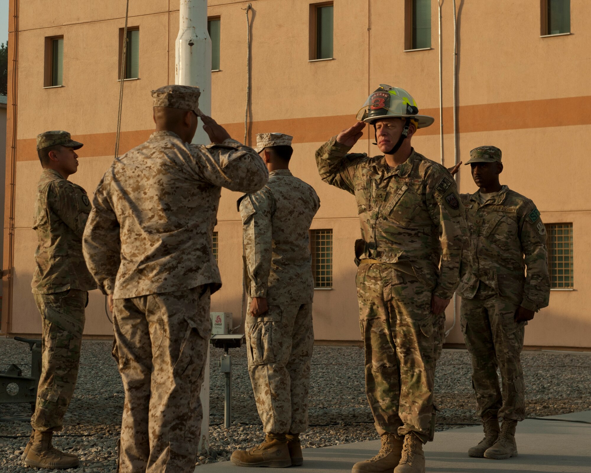 A joint service honor guard salutes the flag during a retreat ceremony, Bagram Airfield, Afghanistan, Sept. 11, 2016. The retreat ceremony was part of a 9/11 remembrance ceremony held at Bagram to remember those who gave their lives 15 years ago. (U.S. Air Force photo by Capt. Korey Fratini