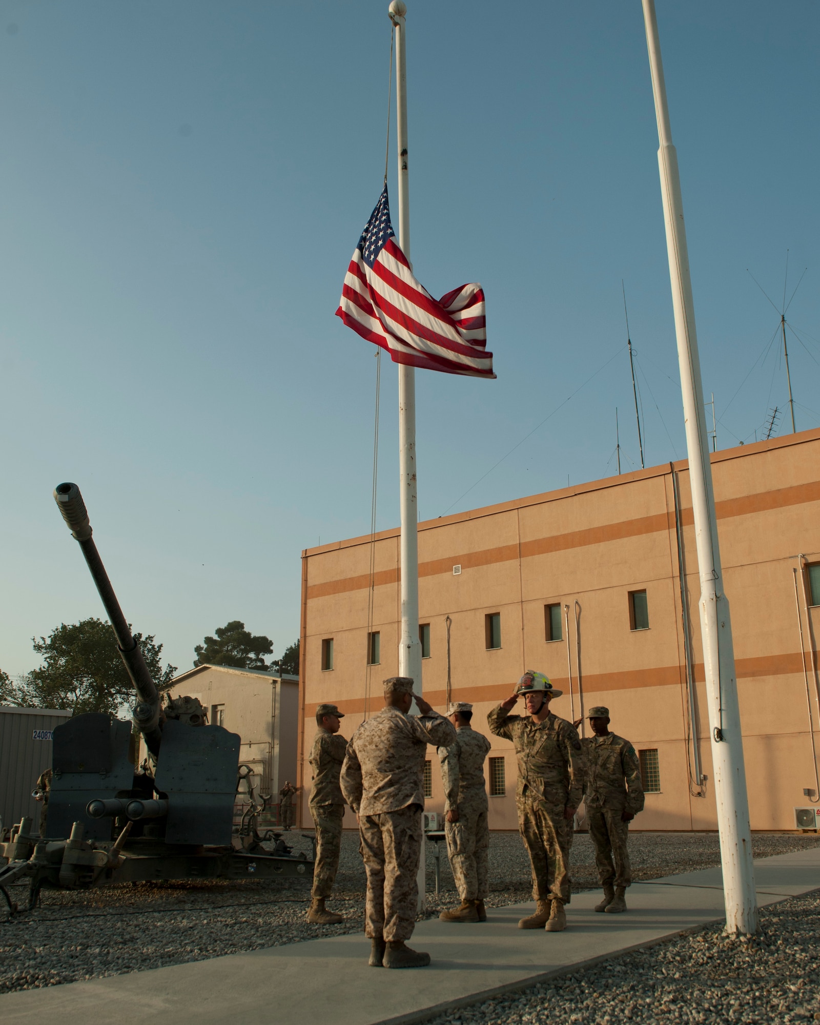 A joint service honor guard lowers the flag during a retreat ceremony as part of a 9/11 remembrance ceremony, Bagram Airfield, Afghanistan, Sept. 11, 2016. The ceremony was held to honor those who lost their lives during the attacks on Sept. 11, 2001, 15 years ago. (U.S. Air Force photo by Capt. Korey Fratini
