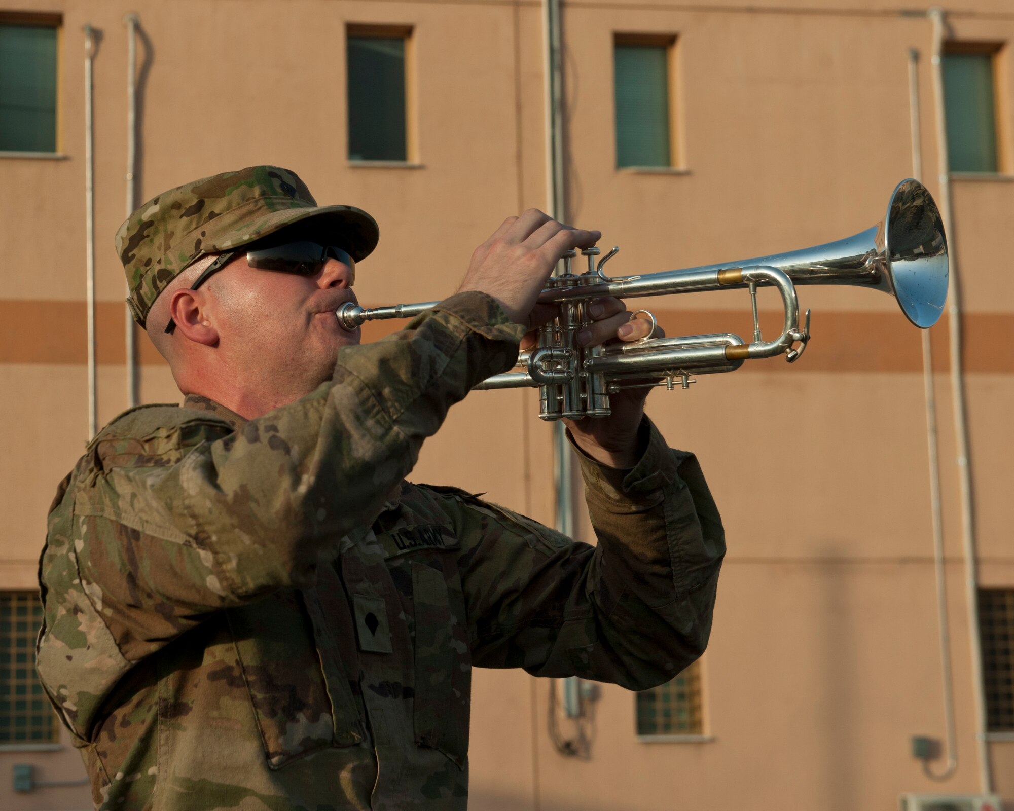 U.S. Army Specialist David Burrell, U.S. Forces Afghanistan Band musician, plays taps during a 9/11 remembrance ceremony, Bagram Airfield, Afghanistan, Sept. 11, 2016. The ceremony brought together servicemembers and civilians from across Bagram to remember those who lost their lives 15 years go. (U.S. Air Force photo by Capt. Korey Fratini)