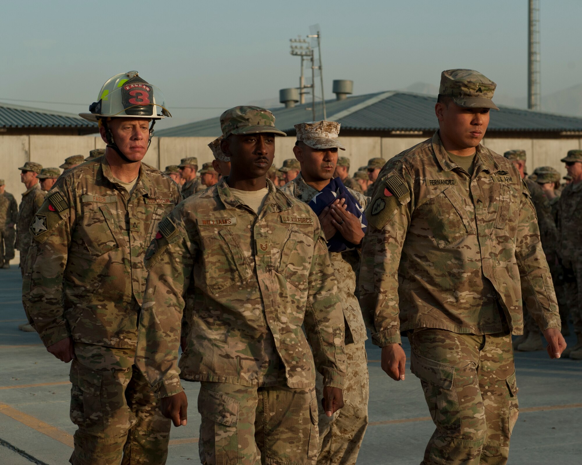 A joint service honor guard protects the flag after completing a retreat ceremony, Bagram Airfield, Afghanistan, Sept. 11, 2016. The honor guard was part of a 9/11 remembrance ceremony to honor those who lost their lives 15 years ago. (U.S. Air Force photo by Capt. Korey Fratini)