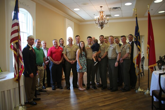 Cpl. Jared Hall (center) poses with his family, Havelock and New Bern chamber of commerce representatives, and with his chain of command during a reception at the New Bern Country Club in New Bern, N.C., Sept. 8. The Hall family received the Military Family of the Quarter Award during the reception. The family received awards, gifts, gift certificates and publicity from the Havelock Military Affairs Committee and the New Bern Military Alliance Committee in appreciation for their service. Hall is an aviation communications technician with Marine Air Support Squadron 1. (U.S. Marine Corps photo by Lance Cpl. Mackenzie Gibson/Released)

