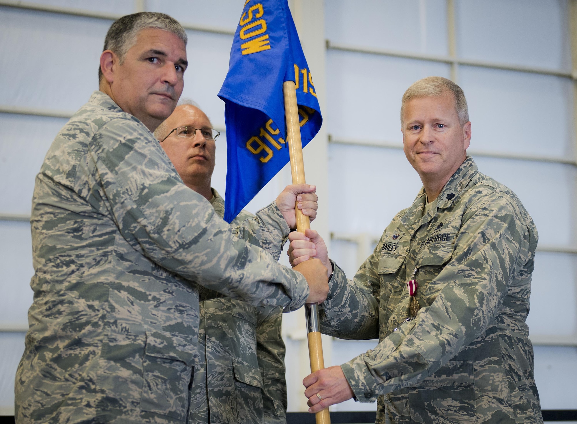 Lt. Col. Kelly Bailey accepts the 919th Special Operations Maintenance Group guidon from Col. James Phillips, 919th Special Operations Wing commander during the group’s assumption of command ceremony Sept. 10 at Duke Field, Fla.  Bailey left his position as the 927th Maintenance Group commander at McDill AFB to take over leadership of the active and Reserve maintenance group.  (U.S. Air Force photo/Tech. Sgt. Jon McCallum)