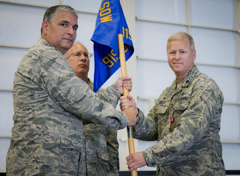 Lt. Col. Kelly Bailey accepts the 919th Special Operations Maintenance Group guidon from Col. James Phillips, 919th Special Operations Wing commander during the group’s assumption of command ceremony Sept. 10 at Duke Field, Fla.  Bailey left his position as the 927th Maintenance Group commander at McDill AFB to take over leadership of the active and Reserve maintenance group.  (U.S. Air Force photo/Tech. Sgt. Jon McCallum)
