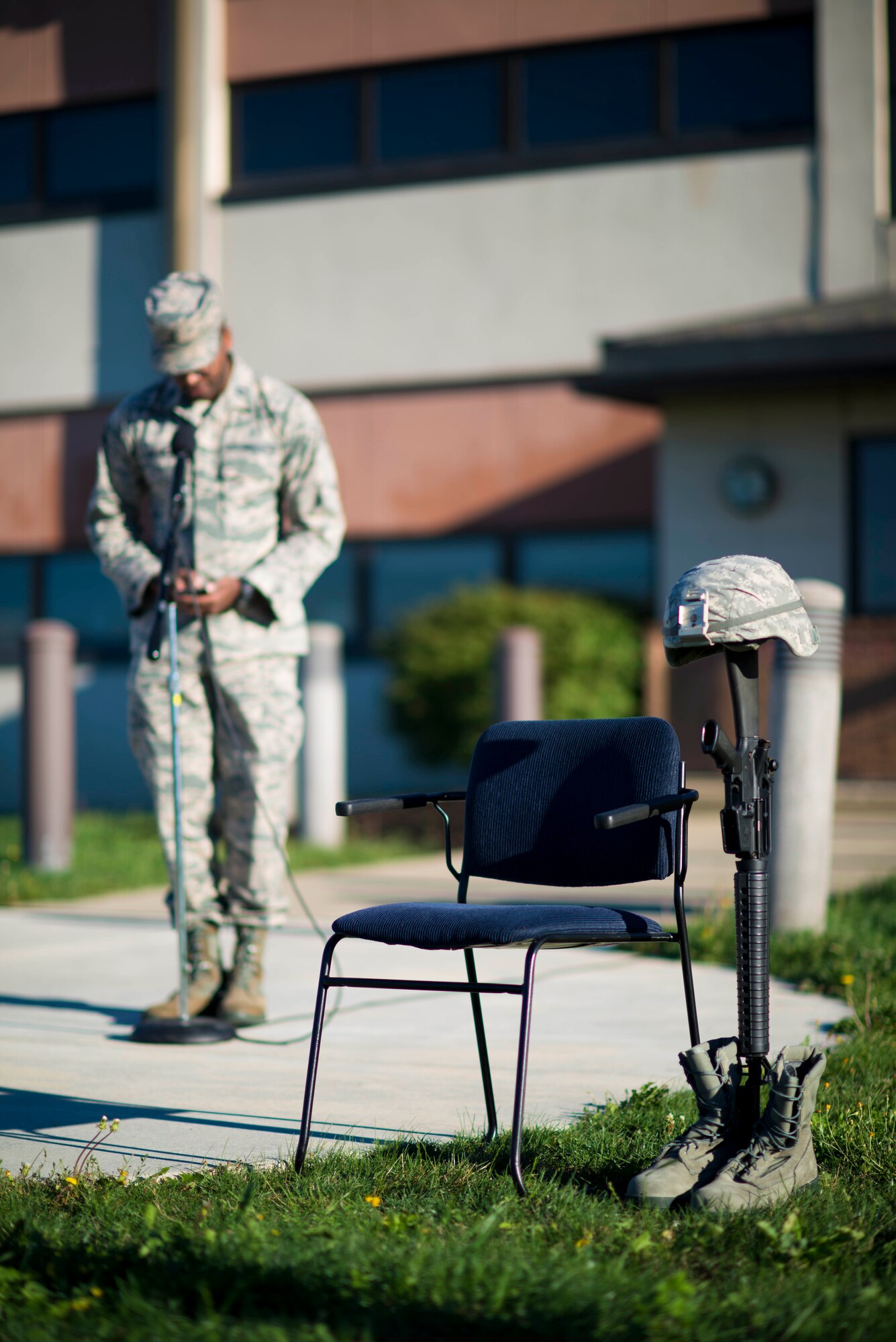 Uniform boots, helmet and rifle are displayed in remembrance of the victims of the 9/11 terrorist attacks as Capt. Marcus Branch, Chaplain, 914th Airlift Wing, leads members in prayer during the 15 year anniversary ceremony, September 11, 2016, Niagara Falls Air Reserve Station, N.Y. (U.S. Air Force by Tech. Sgt. Steph Sawyer) 