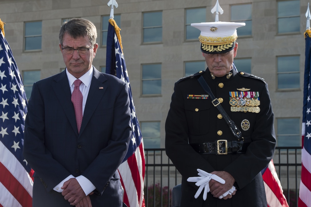 Defense Secretary Ash Carter and Marine Corps Gen. Joe Dunford, chairman of the Joint Chiefs of Staff, observe a moment of silence during a ceremony at the National 9/11 Pentagon Memorial marking the 15th anniversary of the 9/11 attacks, Sept. 11, 2016. DoD photo by Air Force Tech.Sgt. Brigitte N. Brantley