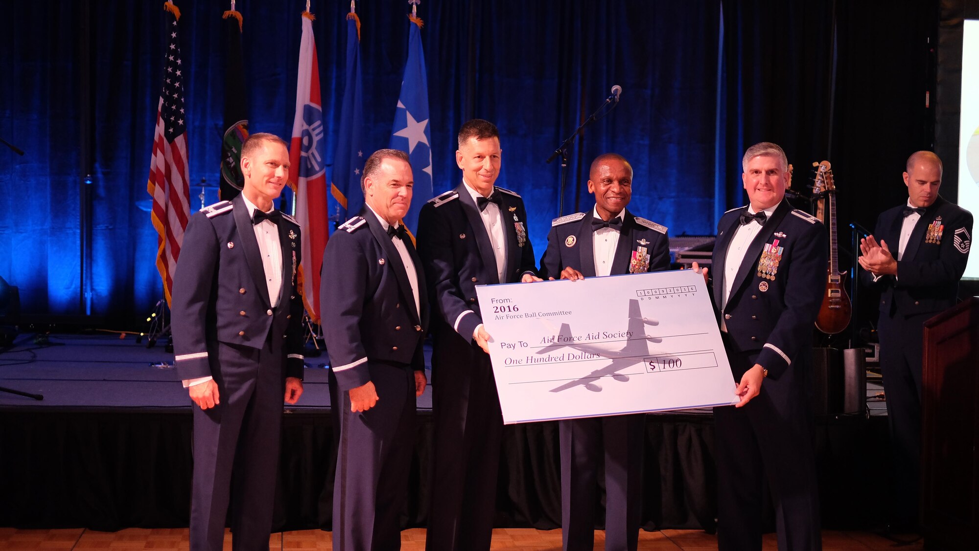 From right, Col. Albert G. Miller, 22nd Air Refueling Wing commander, Gen. Darren W. McDew, U.S. Transportation Command commander, Col. David A. Weishaar, 184th Intelligence Wing commander, Col. Mark S. Larson, 931 ARW commander, and Col. Jarrod K. Frantz, 190 ARW commander, present a check during the Air Force Ball Sept. 10, 2016, Wichita, Kans. In lieu of a gift to McDew, base leadership donated money to the Air Force Aid Society. (U.S. Air Force photo by Senior Airman Preston Webb)