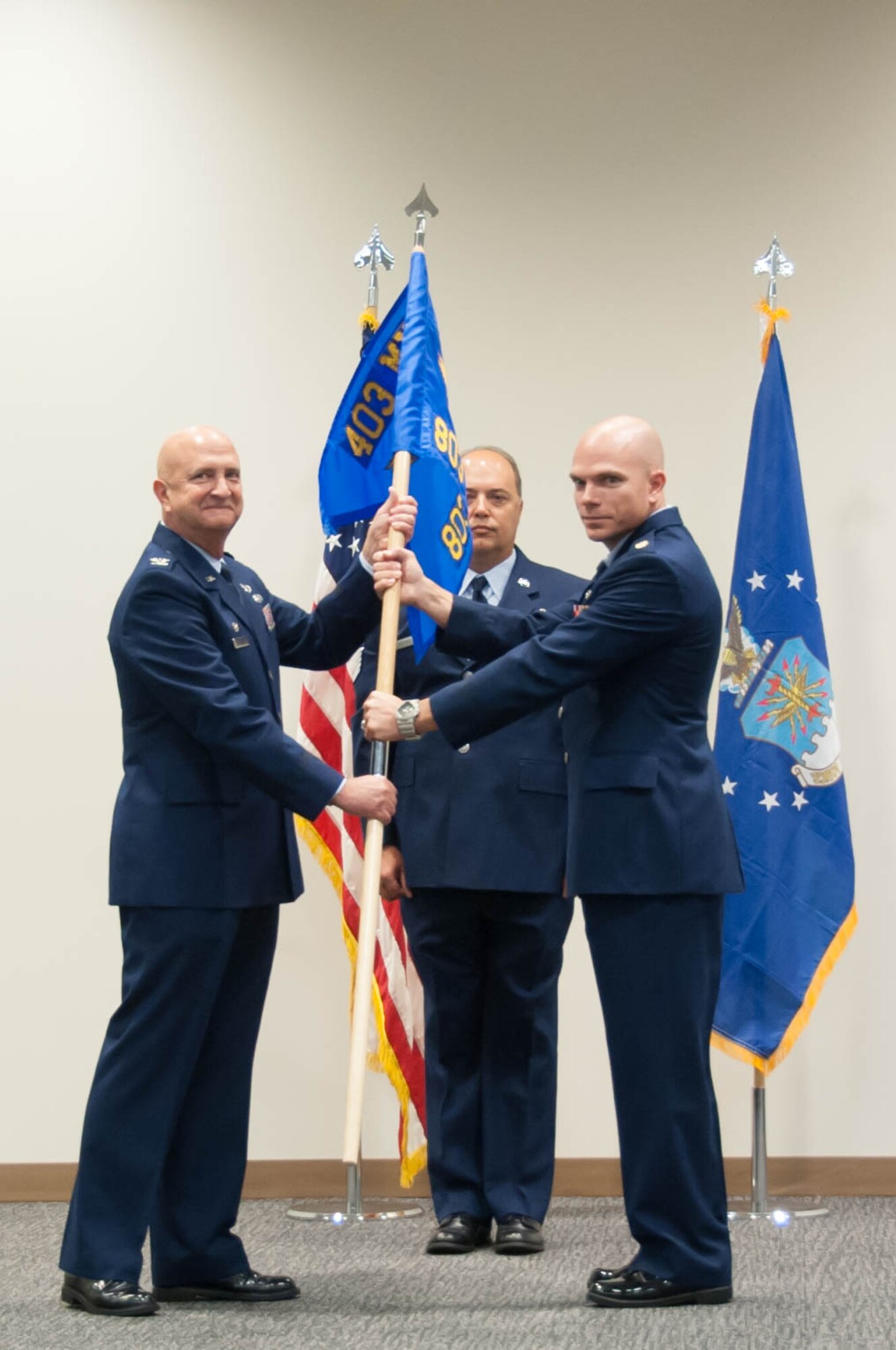 Col. Jay Johnson, 403rd Maintenance Group commander passes the 803rd Aircraft Maintenance Squadron guidon to Maj. Brian Horton, 803rd AMXS commander during a ceremony activating the new unit Sept. 11 at Keesler Air Force Base. (U.S. Air Force photo/Senior Airman Heather Heiney)