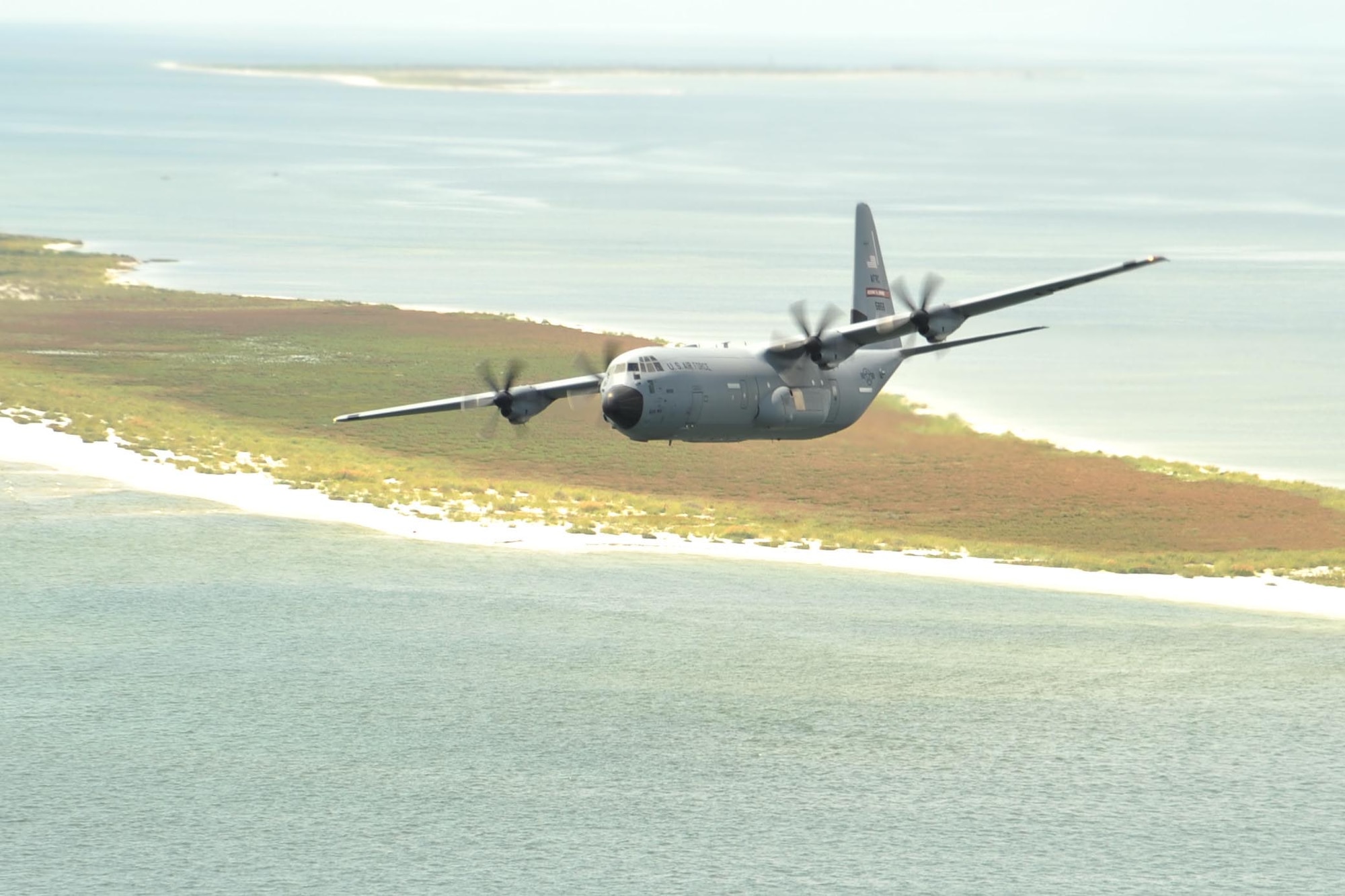 An 815th Airlift Squadron C-130J aircraft flies over the Mississippi Gulfcoast during a four-aircraft training mission Sept. 11, 2016. The aircraft took off from Keesler Air Force Base, Mississippi, and airdropped simulated cargo and heavy equipment over Stennis International Airport, Mississippi. (U.S. Air Force photo by Tech. Sgt. Ryan Labadens)