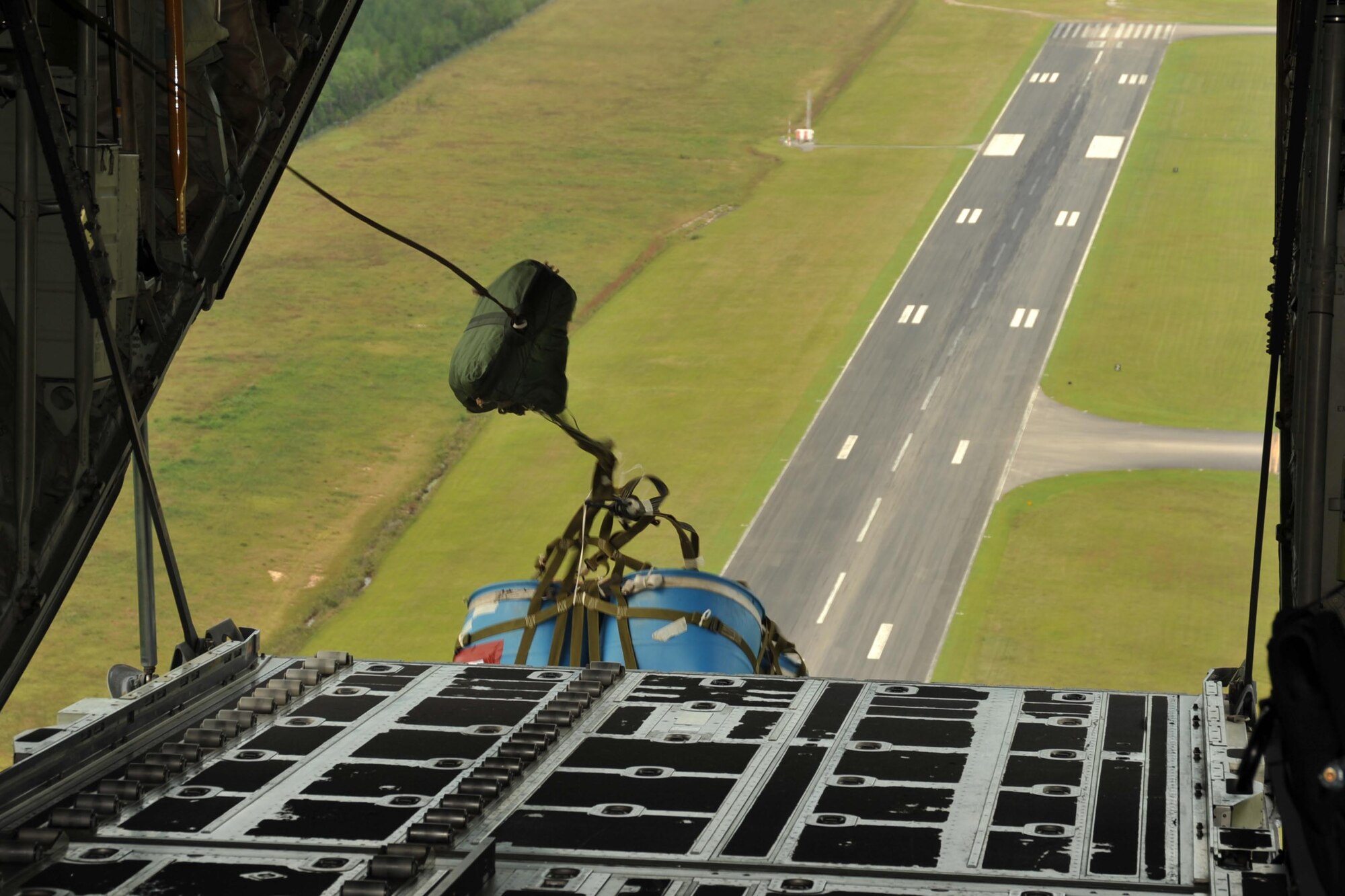 A container delivery system airdrops out the back of an 815th Airlift Squadron C-130J aircraft during a four-aircraft training mission Sept. 11, 2016, over the Mississippi Gulfcoast. The aircraft took off from Keesler Air Force Base, Mississippi, and airdropped simulated cargo and heavy equipment over Stennis International Airport, Mississippi. (U.S. Air Force photo/Tech. Sgt. Ryan Labadens)