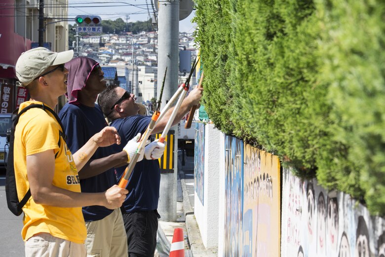 U.S. Navy Sailors at Marine Corps Air Station Iwakuni trim bushes at Ekimae Hoikuen preschool in Iwakuni, Japan, Sept. 8, 2016. The Sailors trimmed bushes, raked leaves and disassembled a swimming pool as part a volunteer project with the Marine Memorial Chapel. (U.S. Marine Corps photo by Lance Cpl. Joseph Abrego)