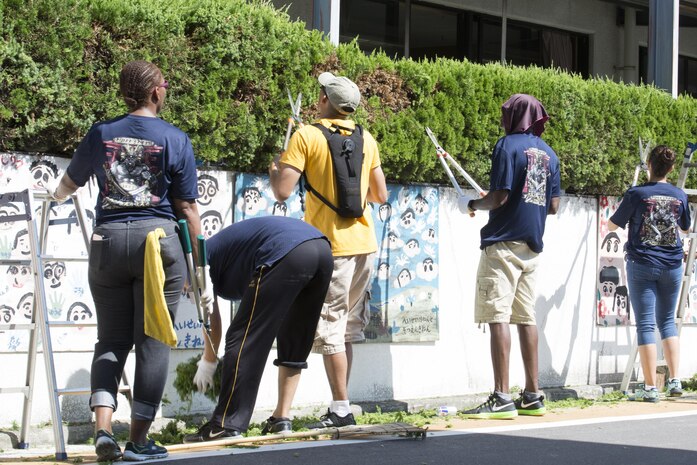 U.S. Navy Sailors at Marine Corps Air Station Iwakuni trim bushes at Ekimae Hoikuen preschool in Iwakuni, Japan, Sept. 8, 2016. The Sailors trimmed bushes, raked leaves and disassembled a swimming pool as part a volunteer project with the Marine Memorial Chapel. (U.S. Marine Corps photo by Lance Cpl. Joseph Abrego)