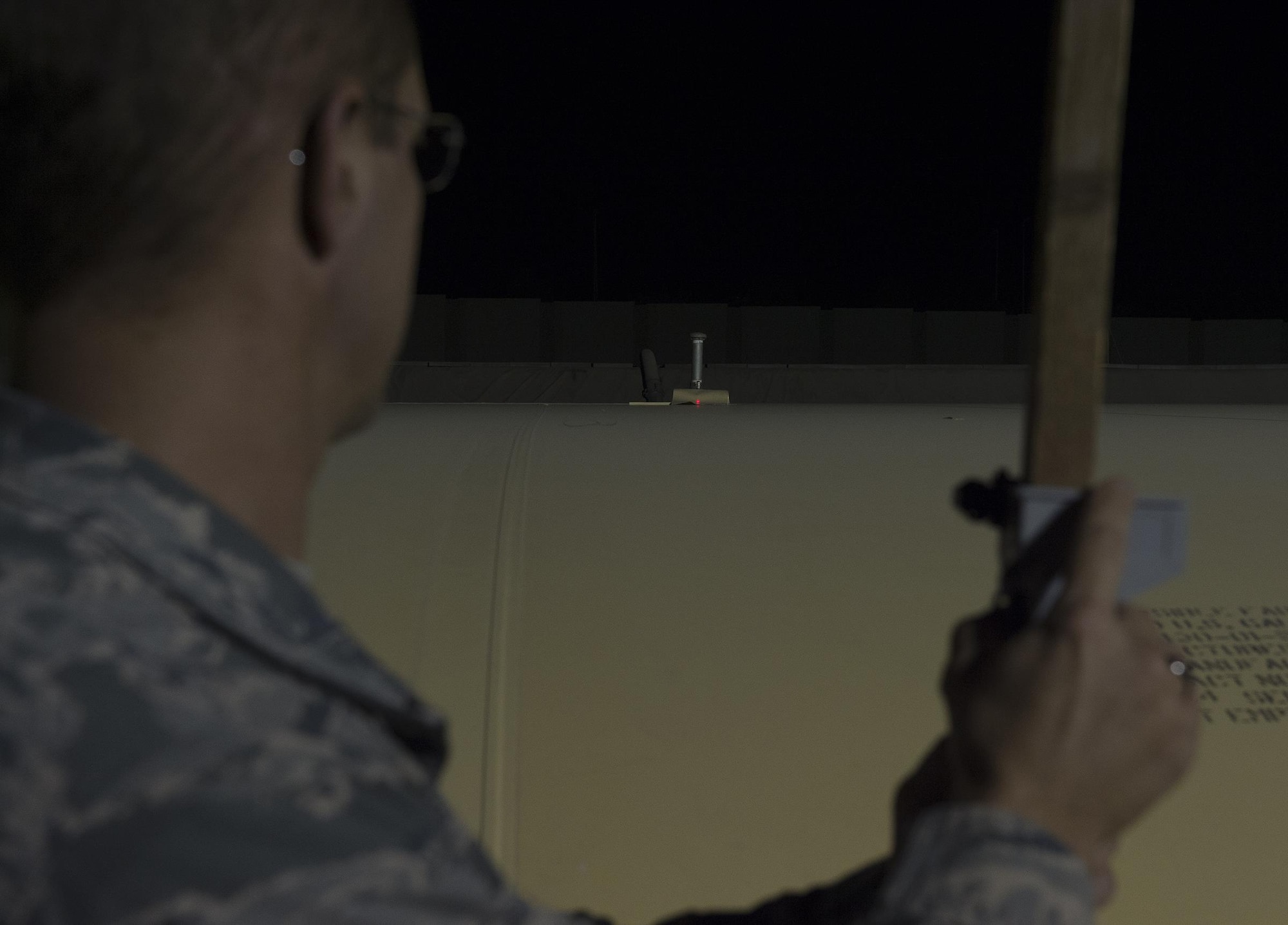 U.S. Air Force Tech. Sgt. Anthony Girod, 380th Logistics Readiness Squadron petroleum, oil & lubrication flight, measures the level of a fuel bladder at an undisclosed location in Southwest Asia August 17, 2016. Girod designed a device which significantly increases the accuracy of fuel measurement in the field. (U.S. Air Force photo by Tech. Sgt. Chad Warren)