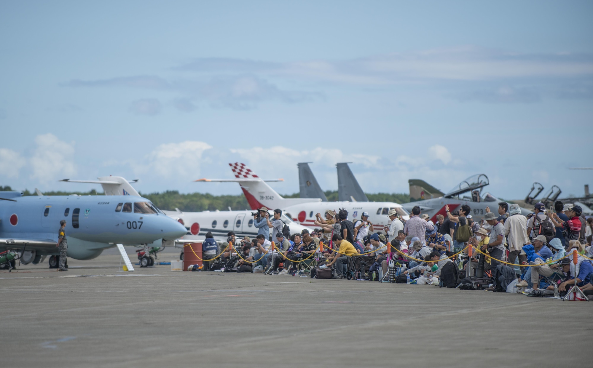 A group of Japanese locals take photos of multiple aircraft during Misawa Air Fest 2016 at Misawa Air Base, Japan, Sept. 11, 2016. More than 80,000 people from across Japan gathered for the air show featuring the Pacific Air Forces' F-16 demonstation team, the Japan Air Self-Defence Force aerial demonstration team Blue Impulse, and multiple other aircraft. (U.S. Air Force photo by Senior Airman Brittany A. Chase)