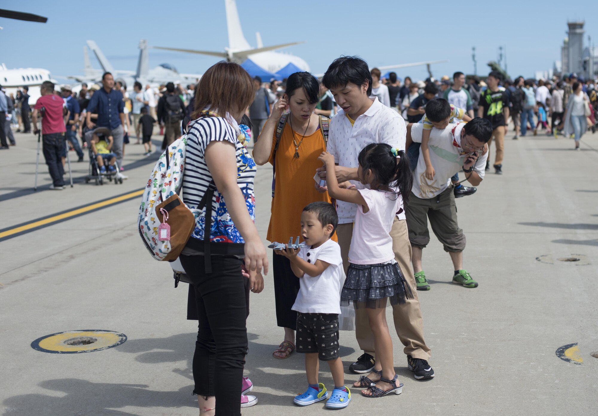 A child plays with his toy F-15 Strike Eagle during Misawa Air Fest 2016 at Misawa Air Base, Japan, Sep. 11, 2016. This year marks the 16th Annual Misawa Air Fest which brought together more than 80,000 people from across Japan. (U.S. Air Force photo by Senior Airman Brittany A. Chase)