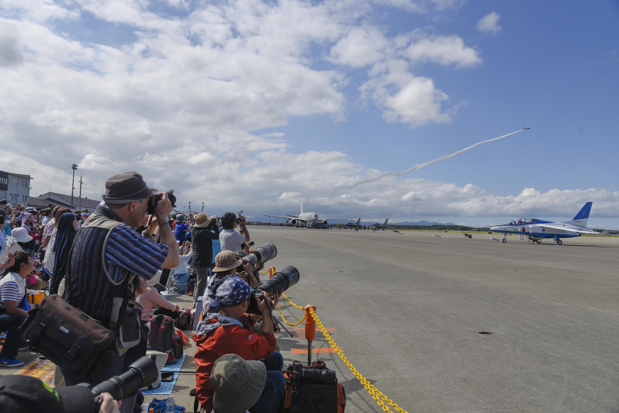 Attendees take photos of the Japan Air Self-Defense Force aerobatic demonstration during Misawa Air Fest 2016 at Misawa Air Base, Japan, Sept. 11, 2016. Approximately 80,000 people attended the event and experienced static displays and demonstrations from both the JASDF and U.S. armed forces. (U.S. Air Force photo by Airman 1st Class Sadie Colbert)