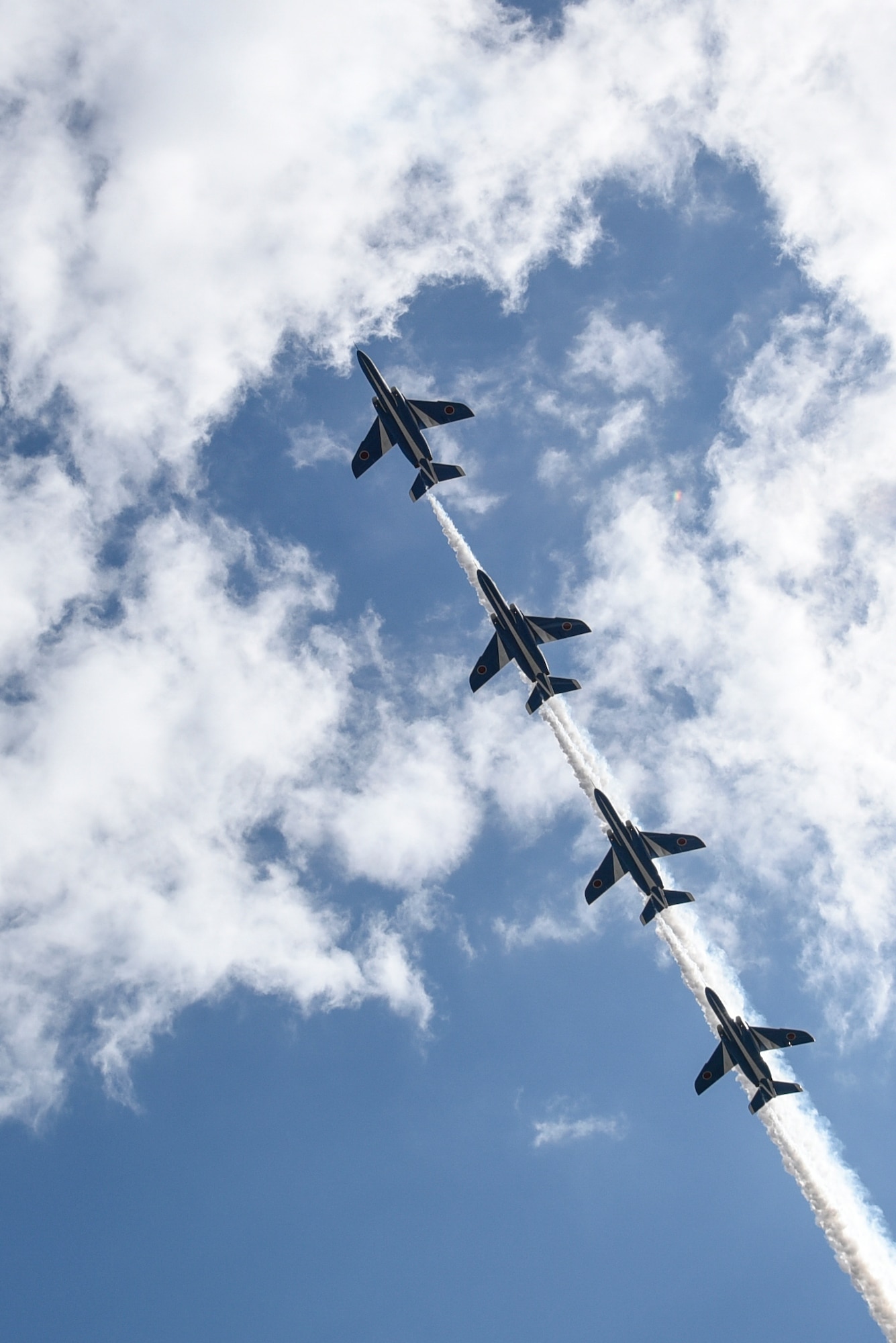 Kawasaki T-4s zoom overhead during an aerobatic demonstration at Misawa Air Base, Japan, Sept. 11, 2016. Blue Impulse, the Japan Air Self-Defense Force aerobatic demonstration team, performed several maneuvers for the air show attendees. The team is assigned with the 4th Air Wing, Matsushima Air Base, Japan. (U.S. Air Force photo by Airman 1st Class Sadie Colbert)

