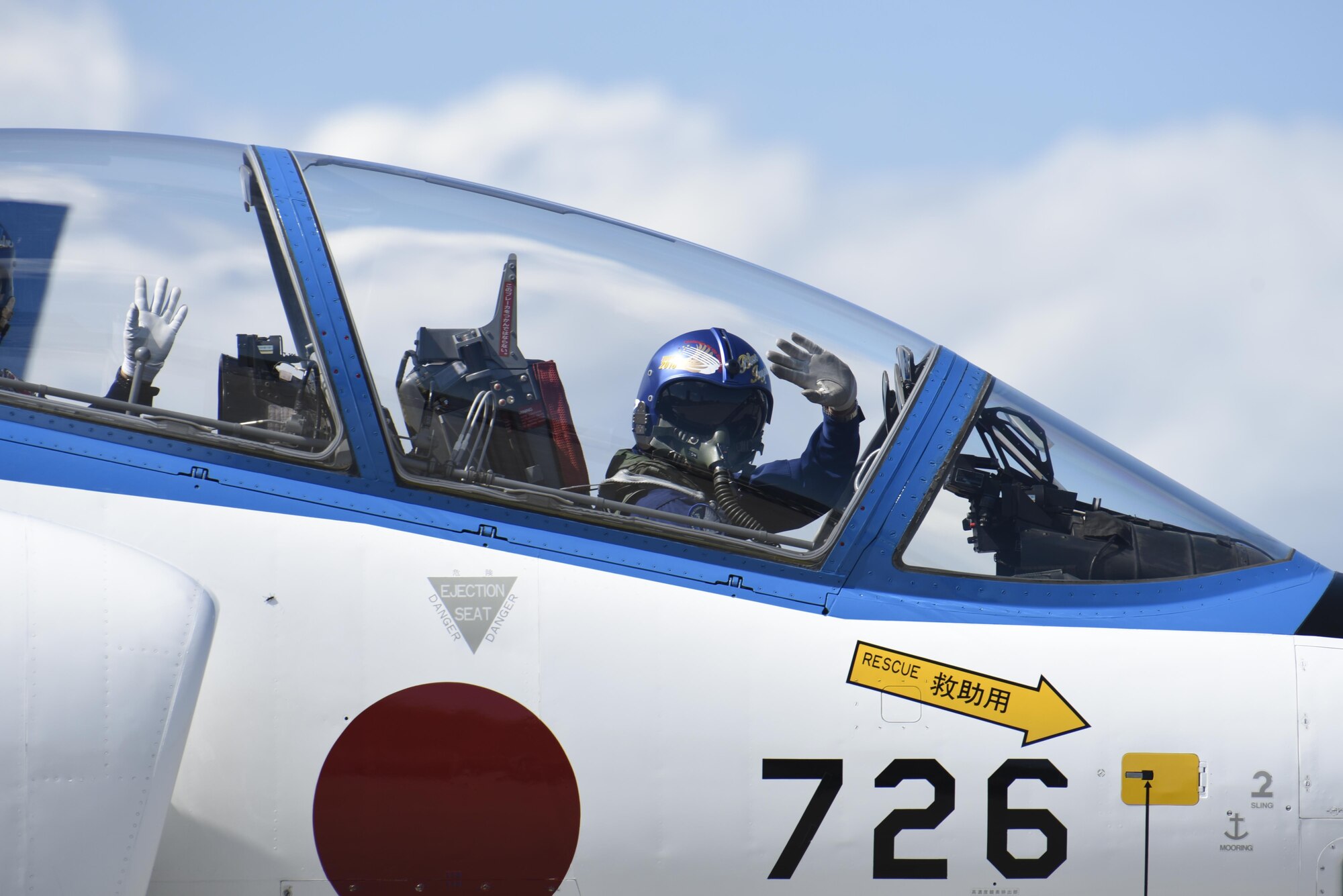 A pair of Blue Impulse pilots wave to the crowd during Misawa Air Fest 2016 at Misawa Air Base, Japan, Sept. 11, 2016. During the air show, attendees saw flying demonstrations of the F-15J, F-2, CH-47 Chinook, U-125 and a UH-60 Black Hawk. (U.S. Air Force photo by Airman 1st Class Sadie Colbert)