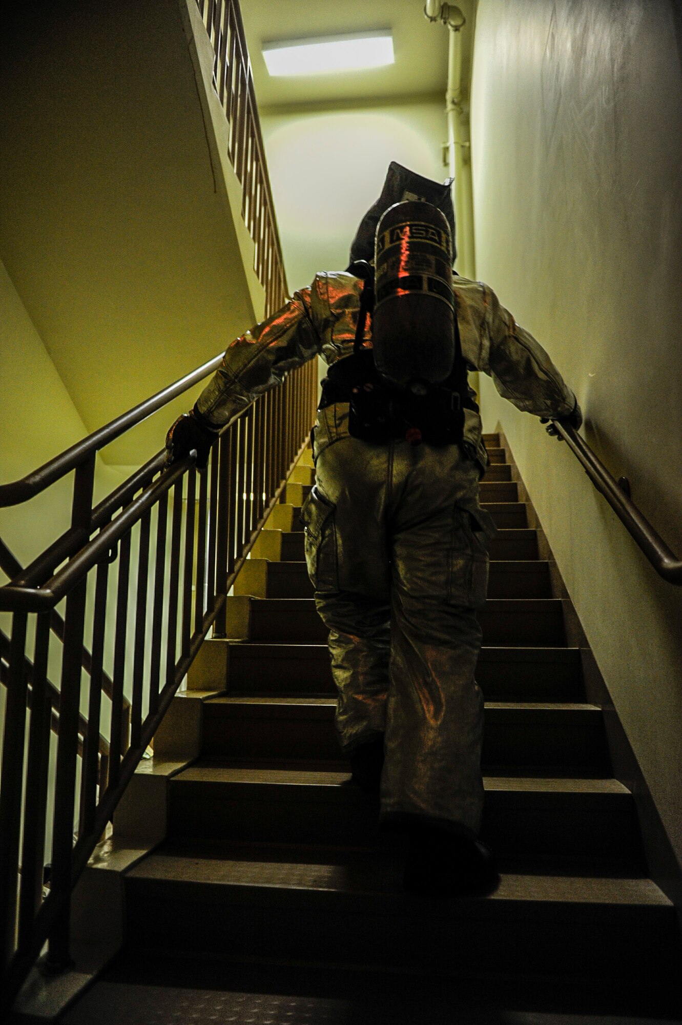A U.S. Air Force firefighter from the 8th Civil Engineer Squadron climbs up a flight of stairs at Kunsan Air Base, Republic of Korea, Sept. 12, 2016. The 9/11 memorial stair climb event is a tribute to the 343 firefighters who gave their lives during the tragic events at the World Trade Center on September 11, 2001. (U.S. Air Force photo by Senior Airman Colville McFee/Released)