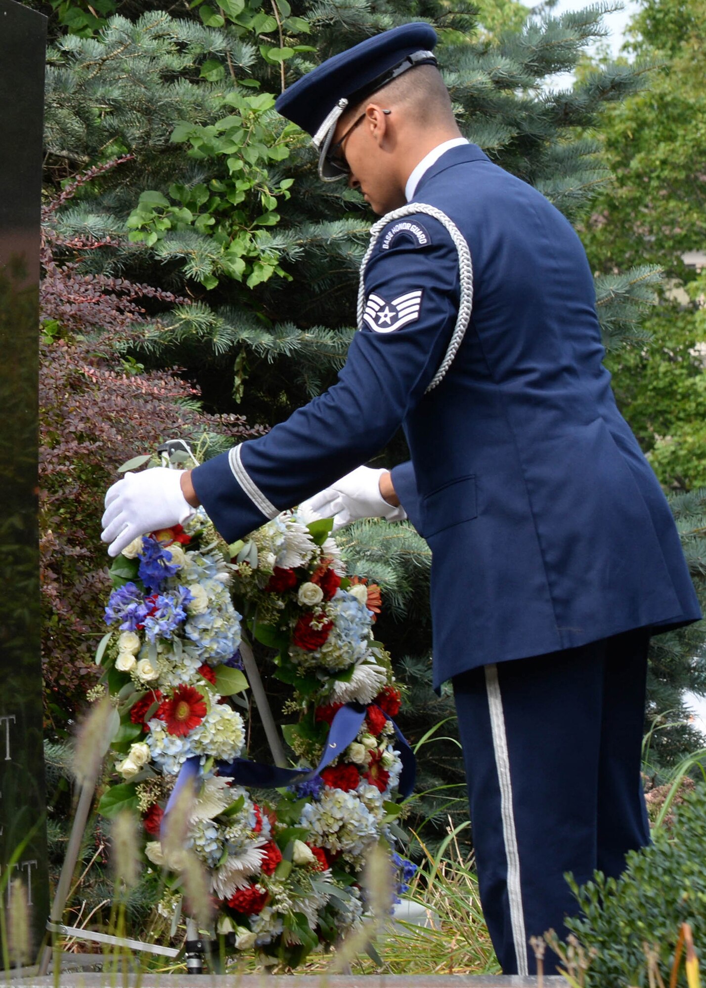 Staff Sgt. Christopher Feliz,, Patriot Honor Guard ceremonial guardsman, places a wreath at the POW/MIA Monument during a 15th Anniversary Memorial Remembrance at Hanscom Air Force Base, Mass., Sept. 9. The ceremony was held in remembrance of those who lost their lives on Sept. 11, 2001. (U.S. Air Force photo by Linda LaBonte Britt)