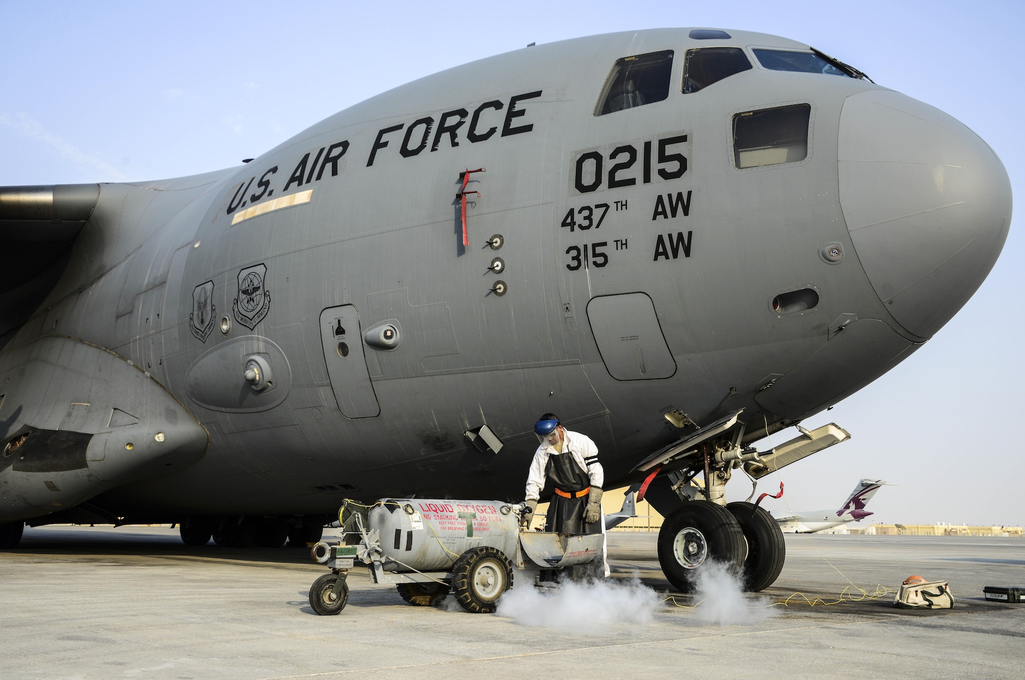 Senior Airman Christopher Martinez, 8th Expeditionary Air Mobility Squadron crew chief, prepares a liquid oxygen tank prior to recharging a C-17 Globemaster III Sept. 3, 2016, at Al Udeid Air Base, Qatar. Martinez works with liquid oxygen that is recharged into an aircraft to provide pure oxygen to aircrews during missions. Martinez joined the Air Force to follow his father’s footsteps and continue his family’s military legacy. (U.S. Air Force photo/Senior Airman Janelle Patiño/Released)