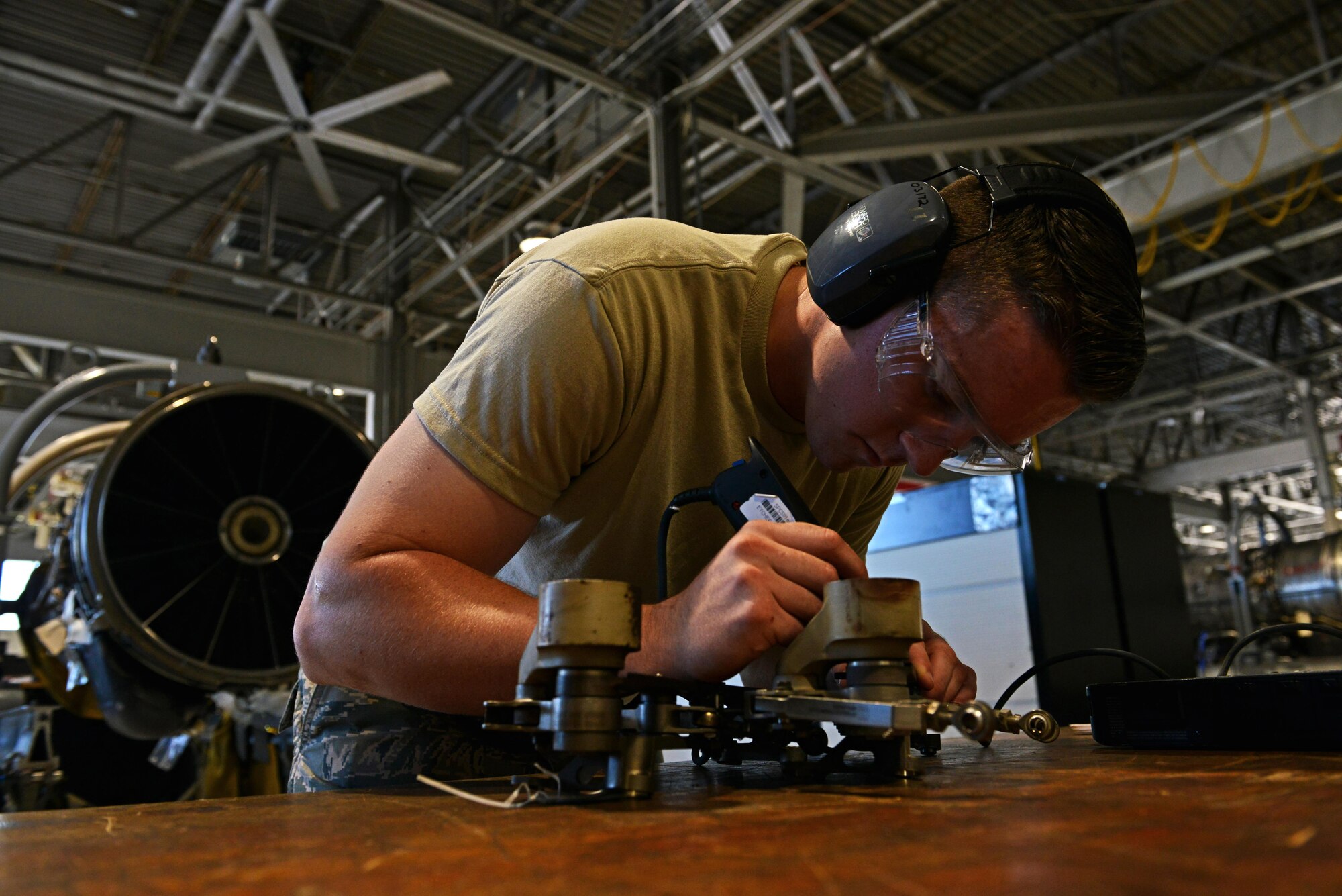 U.S. Air Force Airman Jordan Willis, 20th Component Maintenance Squadron aerospace propulsion apprentice, etches into a bellcrank at Shaw Air Force Base, S.C., Sept. 6, 2016. A bellcrank is part of a mechanism inside an aircraft’s engine which changes the airflow direction. (U.S. Air Force photo by Airman 1st Class Destinee Sweeney)