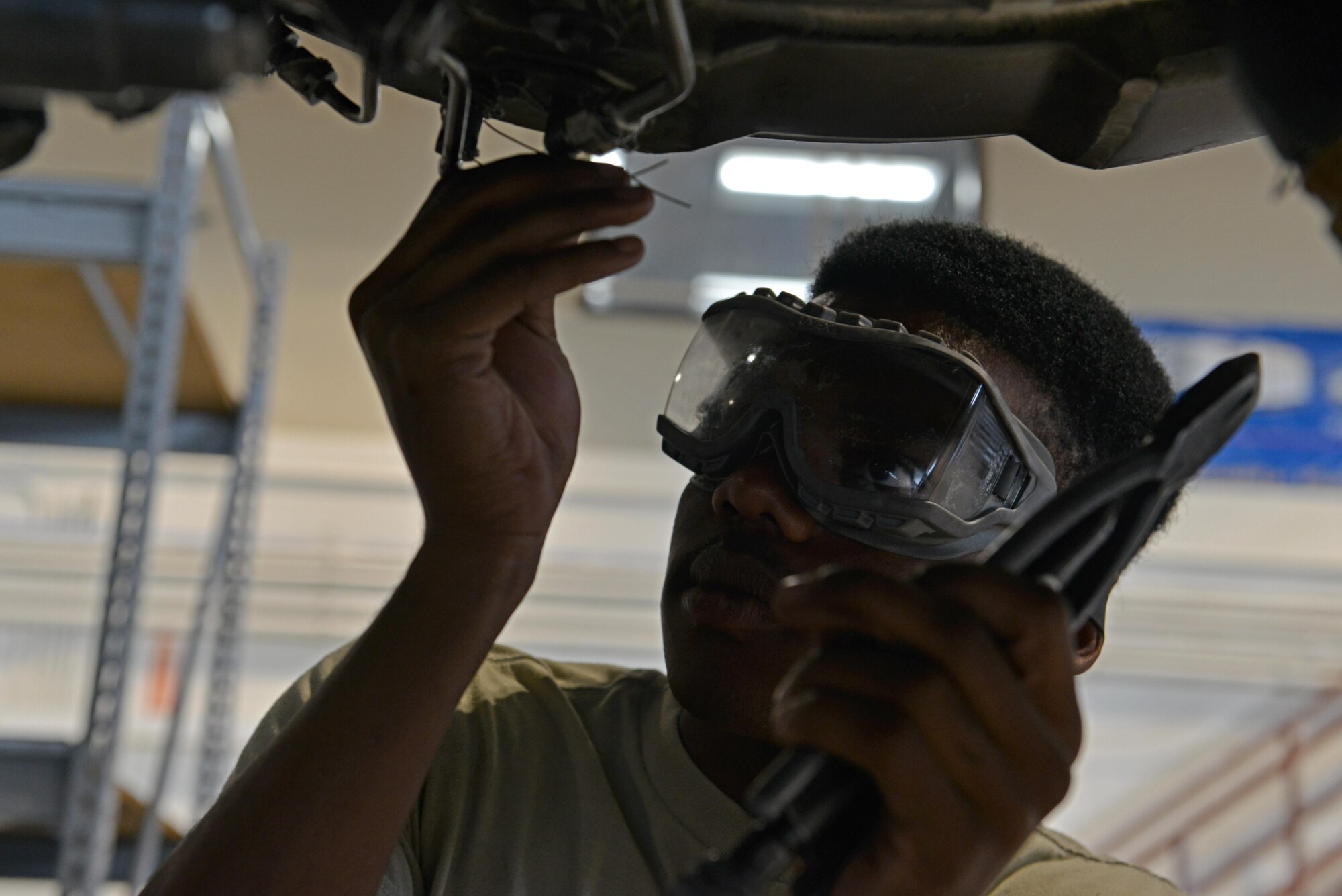U.S. Air Force Airman 1st Class Justin Tillman, 20th Component Maintenance Squadron aerospace propulsion apprentice safety-wires a temp at section two (T2), at Shaw Air Force Base, S.C., Sept. 7, 2016. The T2 takes constant temperature readings and adjusts accordingly to keep an engine functioning properly. (U.S. Air Force photo by Airman 1st Class Destinee Sweeney)