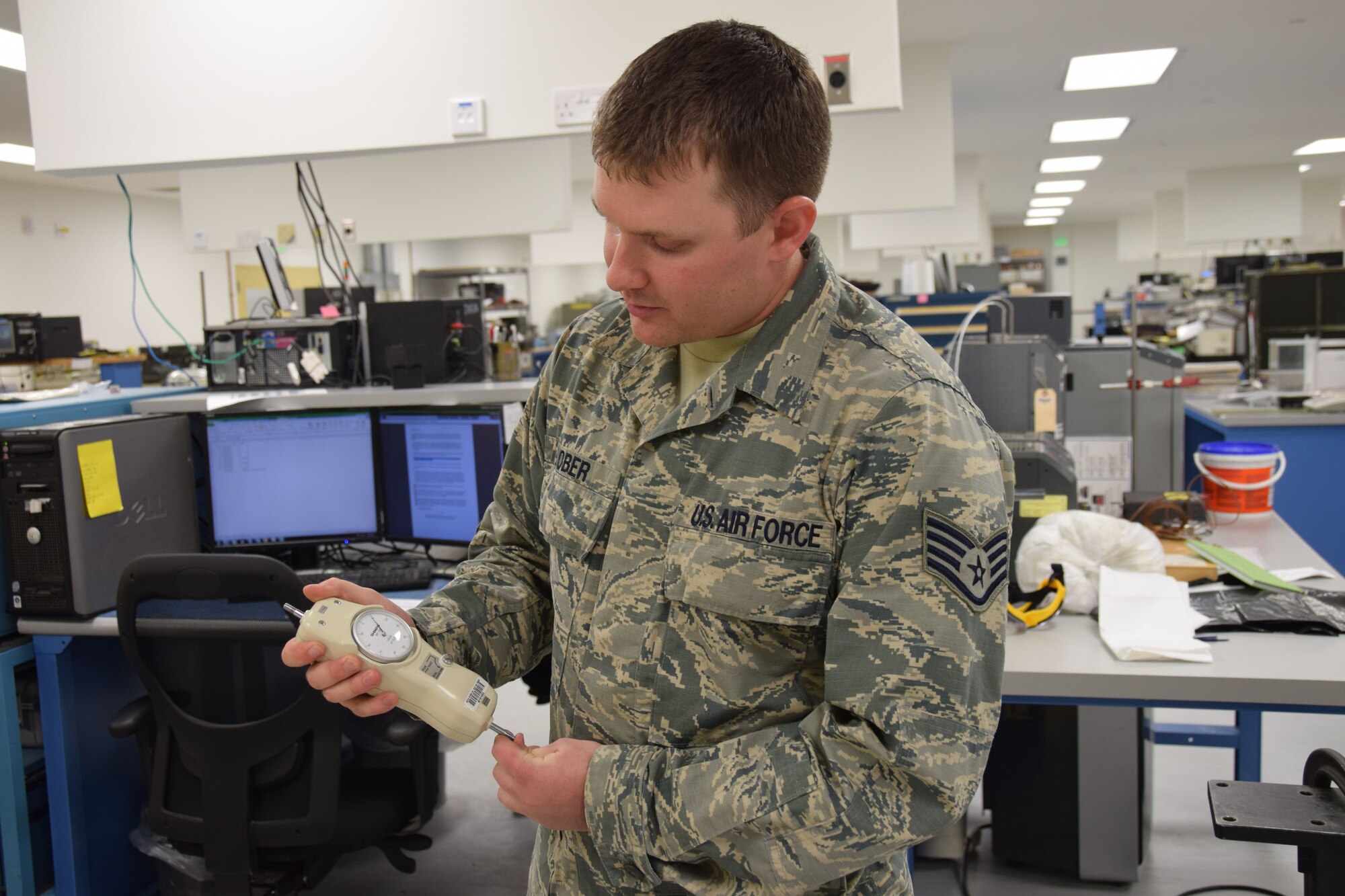 Staff Sgt. Jacob Lober,  379th Expeditionary Expeditionary Maintenance Squadron Precision Measurement Equipment Laboratory craftsman, handles a mechanical force gauge Aug. 24, 2016, Al Udeid Air Base, Qatar. The 379th EMXS's PMEL supports approximately 13,700 pieces of test, measurement and diagnostice equipment in the area of responsibility. (U.S. Air Force photo/Technical Sgt. CarlosJ.  Treviño/Released)