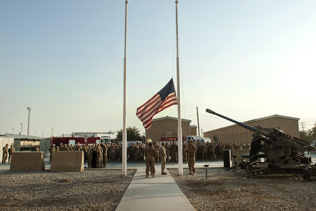 A joint service honor guard lowers the American flag to half-staff during a 9/11 remembrance ceremony at Bagram Airfield, Afghanistan, Sept. 11, 2016. Air Force photo by Capt. Korey Fratini