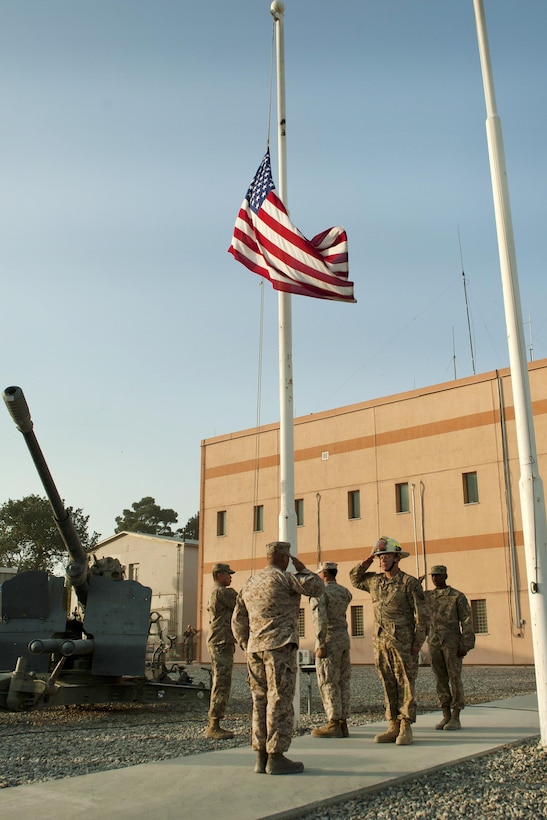 A joint service honor guard renders honors after lowering the American flag to half-staff during a 9/11 remembrance ceremony at Bagram Airfield, Afghanistan, Sept. 11, 2016. Air Force photo by Capt. Korey Fratini