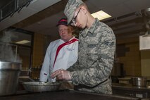 The Dakota Inn Dining Facility executive chef instructs an Airman to check the temperature of the food at Minot Air Force Base, N.D., Sept. 7, 2016. Each dining period of breakfast, lunch and dinner is cooked fresh by chefs and Airmen. (U.S. Air Force photo/Airman 1st Class Christian Sullivan)