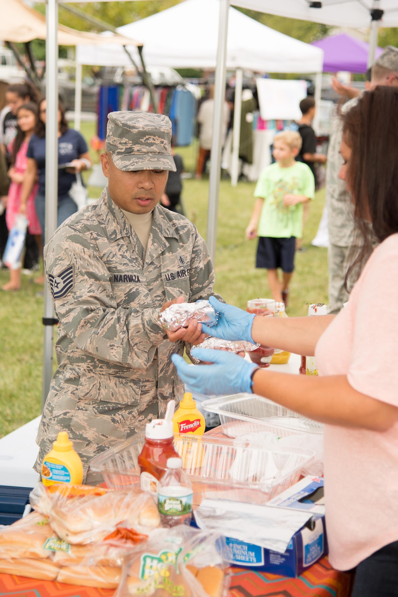 Tech Sgt. Joel Narvaza, 436th Medical Operations Squadron medical technician, orders hotdogs at the Emergency Management Block Party Sept. 1, 2016, in the Eagle Heights family housing on Dover Air Force Base, Del. Sponsored by the 436 Civil Engineering Squadron Emergency Management Flight, the block party kicked off National Preparedness Month where attendees were able to acquire useful information from numerous base and local agencies. (U.S. Air Force photo by Mauricio Campino)