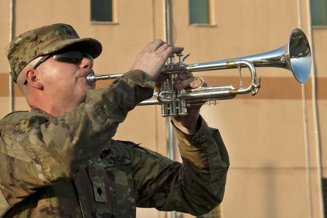 Army Spc. David Burrell plays taps during a 9/11 remembrance ceremony at Bagram Airfield, Afghanistan, Sept. 11, 2016. Burrell is a musician assigned to the U.S. Forces Afghanistan Band. Air Force photo by Capt. Korey Fratini