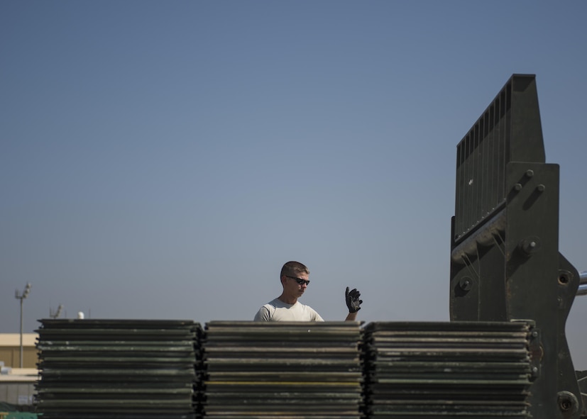 Tech. Sgt. Bradley Stevens, 455th Expeditionary Logistics Squadron Central Command Material Recovery Element team lead, guides a forklift to a high line dock, Bagram Airfield, Afghanistan, Sept. 9, 2016. CMRE accounts for and redeploys war reserve assets. The team palletized AM-2 Matting to be transported to another base for use. (U.S. Air Force photo by Senior Airman Justyn M. Freeman)