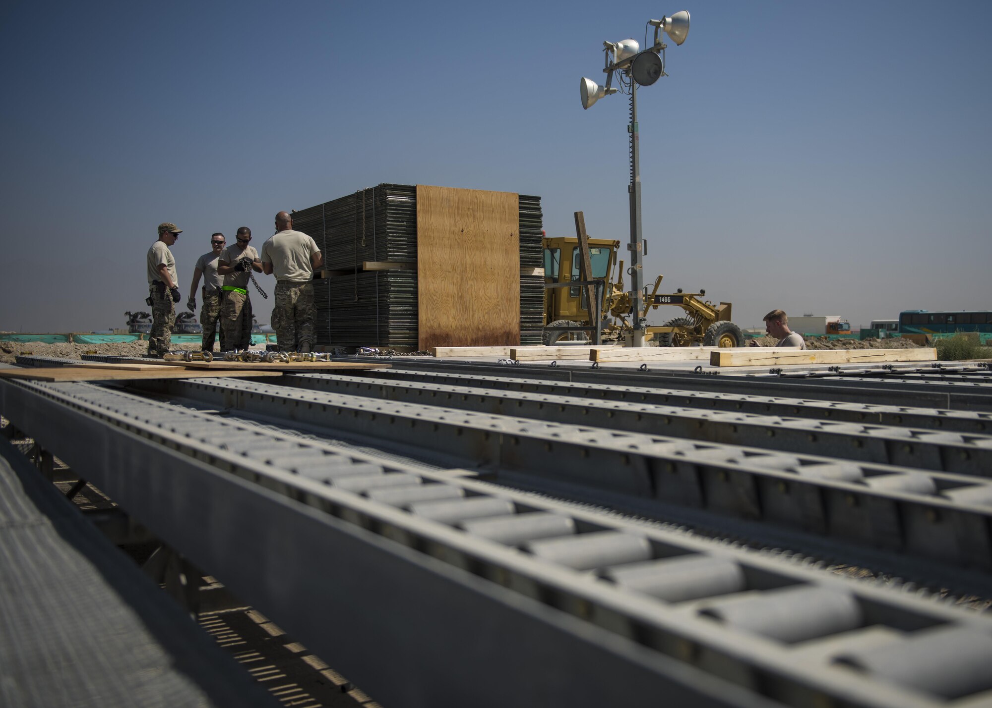 Airmen from the 455th Expeditionary Logistics Squadron Central Command Material Recovery Element, construct a pallet of AM-2 matting, Bagram Airfield, Afghanistan, Sept. 9, 2016. CMRE accounts for and redeploys war reserve assets. The team palletized the matting and transported it to another base. The matting is used to form runways, taxiways, parking and other areas required for aircraft operations and maintenance. (U.S. Air Force photo by Senior Airman Justyn M. Freeman)