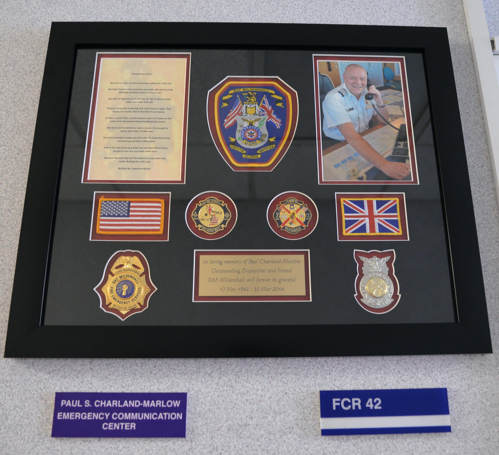 A tribute to Paul Charland-Marlow, former 100th Civil Engineer Squadron Fire Department lead dispatcher, is on display outside the emergency communication center Sept. 9, 2016, on RAF Mildenhall, England. Charland-Marlow passed away March 30, 2016, so the firefighters decided to put together a tribute in his memory. (U.S. Air Force photo by Karen Abeyasekere)