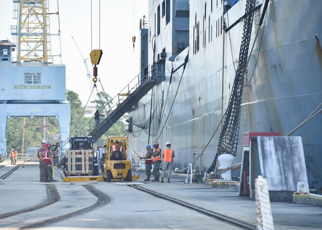 Marines with Navy Cargo Handling Battalion One, unload a pallet of munitions from the U.S. Naval Ship Sacagawea Sept. 7, 2016, at Joint Base Charleston - Weapons Station, South Carolina. Before arriving at the JB Charleston-WS, the Sacagawea was prepositioned with more than 2,000 pallets of ordnance. The ship’s mission is to sustain a Marine Corps expeditionary brigade for up to 30 days, enabling a quick response when needed. (U.S. Air Force Photo/Airman Megan Munoz)