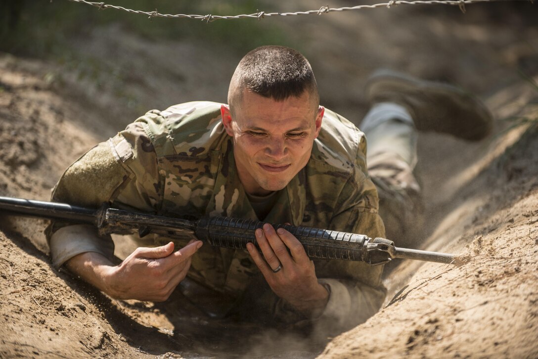 Army Reserve Drill Sergeant of the Year competitor, Sgt. 1st Class Jason Scott, 95th Training Division (IET), high crawls under the wire obstacle on the fit to win obstacle course during the 2016 TRADOC Drill Sergeant of the Year competition, Sept. 8.  Scott and Sgt. Ryan Moldovan, 98th Training Division (IET), are facing off in a head to head competition at Fort Jackson, S.C., to see who will be named the 2016 Army Reserve Drill Sergeant of the Year.(U.S. Army Reserve photo by Sgt. 1st Class Brian Hamilton/ released)