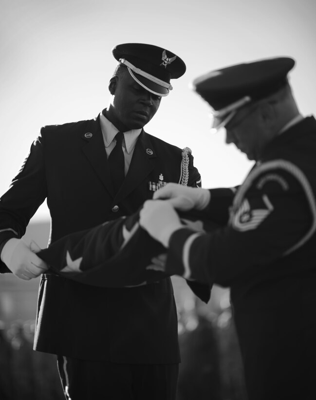 Base Honor Guard members Master Sgt. Jermell Motley and Master Sgt. Thomas Perreault complete the folding of the flag as part of a remembrance ceremony in honor of the victims of the 9/11 attacks on its 15 year anniversary, September 11, 2016, Niagara Falls Air Reserve Station, N.Y. (U.S. Air Force photo by Tech. Sgt. Steph Sawyer) 
