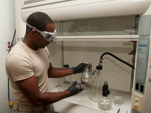 Senior Airman Jordan Smith, a fuels distribution operator with the 5th Logistics Readiness Squadron, cleans a fuel jar before he uses it to sample fuel at Minot Air Force Base, N.D., Aug. 31, 2016. The fuel lab is responsible for sampling for any particles that may contaminate the fuel. (U.S. Air Force photo/Airman 1st Class Jonathan McElderry)