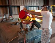Senior Airman Jordan Smith, a fuels distribution operator with the 5th Logistics Readiness Squadron, pours fuel into a bowser lob at Minot Air Force Base, N.D., Aug. 31, 2016. This process takes place once the fuel has already been tested for reuse. (U.S. Air Force photo/Airman 1st Class Jonathan McElderry)