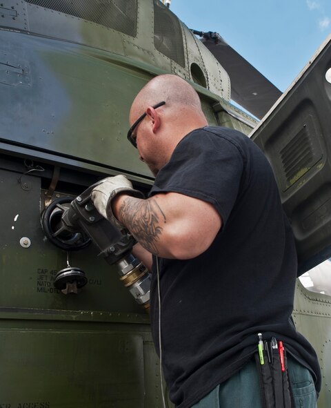 Darren Bivins, member of the 582nd Helicopter Group, refuels a UH-1N Iroquois helicopter on the flightline at Minot Air Force Base, N.D., Sept. 6, 2016. After the 5th Logistics Readiness Squadron’s Petroleum, Oils and Lubricants shop tests the fuel for any contamination, the reusable fuel is then used to refuel various aircrafts from helicopters to B-52H Stratofortresses. (U.S. Air Force photo/Airman 1st Class Jonathan McElderry) 
