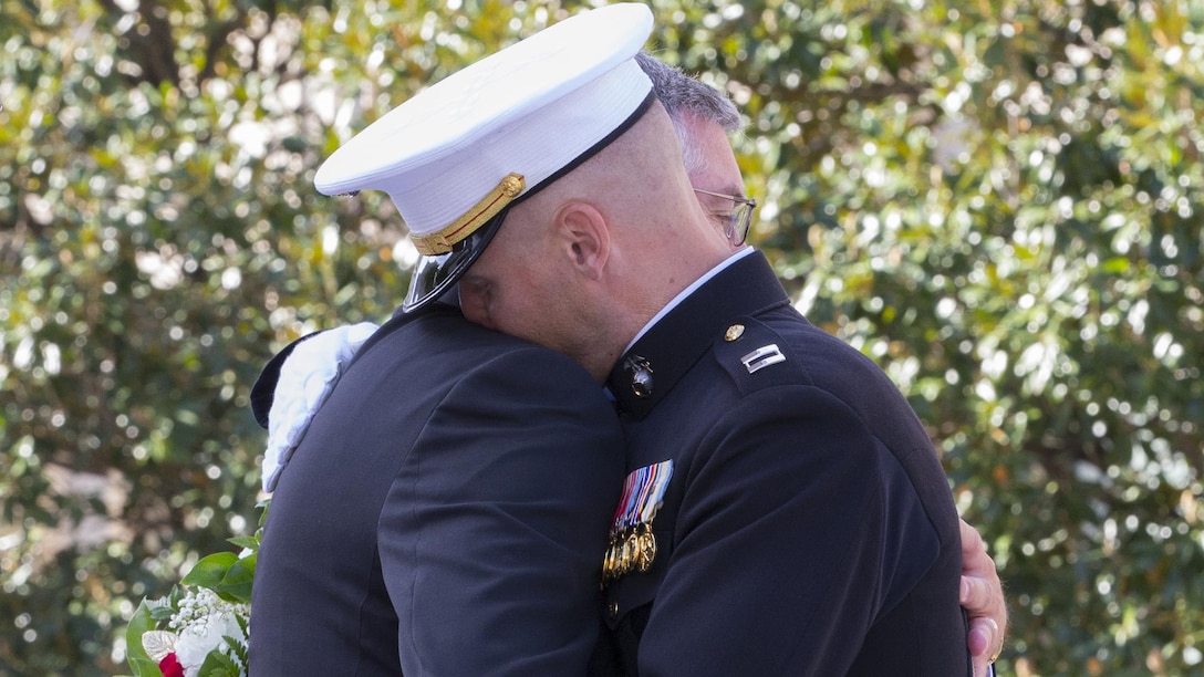 Capt. Eric M. Montgomery hugs his father after receiving the wreath for his brother, Lance Cpl. Brian Montgomery, who was killed while in Haditha, Iraq in 2005, during a 9/11 Remembrance Ceremony in Nashville, Tenn., Sept 11, 2016. Marine Week Nashville is a chance to reconnect with our Marines, sailors, veterans and their families from different generations.