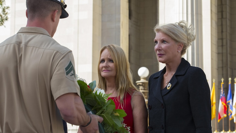 U.S. Marine with Special Purpose Marine Air Ground Task Force – Nashville hands a wreath to the mother of Lance Cpl Daniel "Gabe" Raney during a 9/11 Remembrance Ceremony in Nashville, Tenn., Sept. 11, 2016. Marine Week Nashville is a chance to reconnect with our Marines, sailors, veterans and their families from different generations.