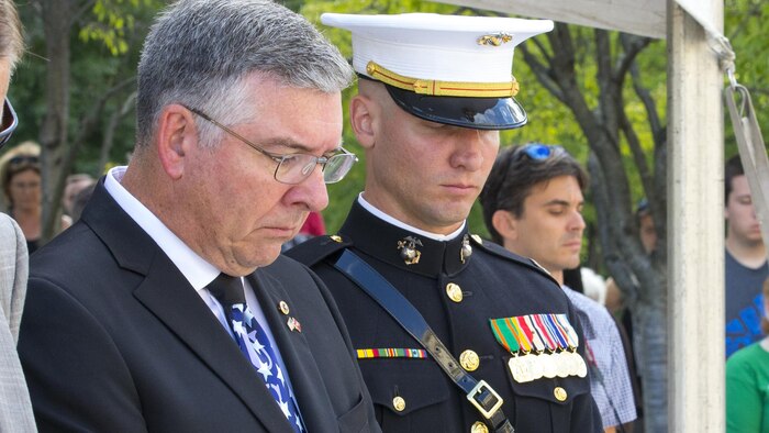 Capt. Eric M. Montgomery, right, and his father, left, bow their heads during the 9/11 Remembrance Ceremony, Nashville, Tenn., Sept. 11, 2016. Marine Week Nashville is a chance to reconnect with our Marines, sailors, veterans and their families from different generations.