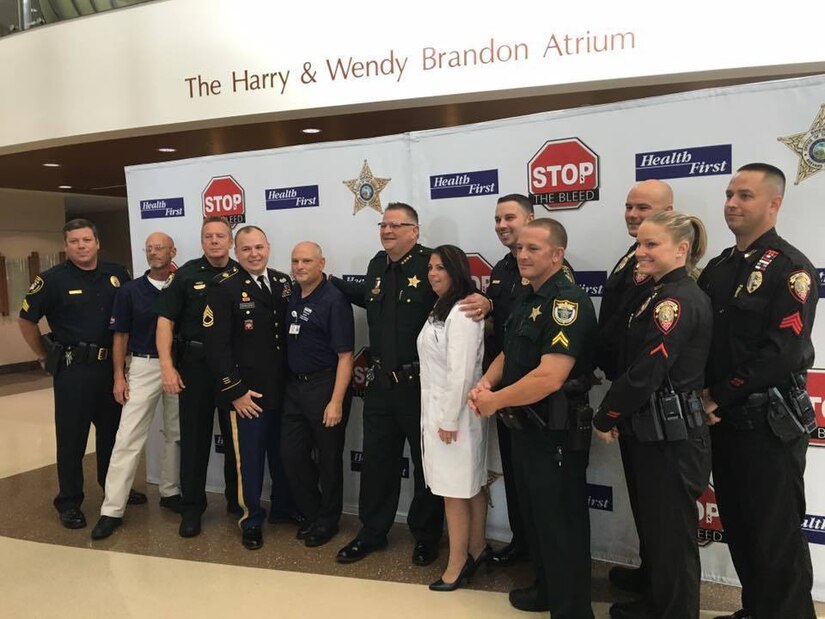 Demonstrators and instructors for Stop The Bleed campaign pose for photo during press conference held September 1 at Health First Holmes Regional Medical Center.