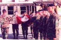 Alpha Company, 3rd Infantry Regiment, “The Old Guard” flag detail folds the U.S. Garrison Flag that has been hanging over the Pentagon after the 9/11 attack, October 11, 2001. PFC Gregory "Erick" Reed, is the second Soldier in formation on the right facing the flag. Today, the flag’s condition is as it was when it was retired. Never cleaned it is still soot-stained and has a small rip in one area. The flag resides in the care of the Army’s Center of Military History and serves as a revered symbol of American pride, ideals and resolve in the face of adversity. (Courtesy photo)