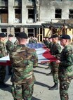 Alpha Company, 3rd Infantry Regiment, “The Old Guard” flag detail folds the U.S. Garrison Flag that has been hanging over the Pentagon after the 9/11 attack, October 11, 2001. PFC Gregory "Erick" Reed, is the second Soldier in formation on the right facing the flag. Today, the flag’s condition is as it was when it was retired. Never cleaned it is still soot-stained and has a small rip in one area. The flag resides in the care of the Army’s Center of Military History and serves as a revered symbol of American pride, ideals and resolve in the face of adversity. (Courtesy photo)