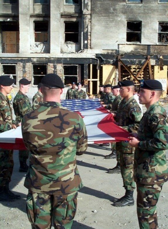 Alpha Company, 3rd Infantry Regiment, “The Old Guard” flag detail folds the U.S. Garrison Flag that has been hanging over the Pentagon after the 9/11 attack, October 11, 2001. PFC Gregory "Erick" Reed, is the second Soldier in formation on the right facing the flag. Today, the flag’s condition is as it was when it was retired. Never cleaned it is still soot-stained and has a small rip in one area. The flag resides in the care of the Army’s Center of Military History and serves as a revered symbol of American pride, ideals and resolve in the face of adversity. (Courtesy photo)