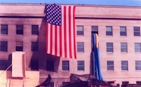 The Garrison Flag hanging over the Pentagon after the 9/11 attack, October 11, 2001. Today, the flag’s condition is as it was when it was retired. Never cleaned it is still soot-stained and has a small rip in one area. The flag resides in the care of the Army’s Center of Military History and serves as a revered symbol of American pride, ideals and resolve in the face of adversity. (Courtesy photo)