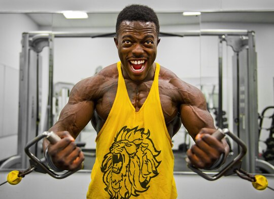 Senior Airman Terrence Ruffin, 16th Electronic Warfare Squadron, strains for an extra rep on a weight machine at the fitness center on Eglin Air Force Base, Fla. Ruffin, currently the youngest professional bodybuilder on the circuit at age 22, will compete at the largest bodybuilding competition in the world Sept 17. (U.S. Air Force photo/Samuel King Jr.)
